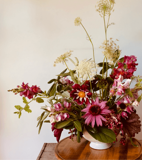 An arrangement of pink and white flowers in a vase.