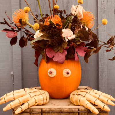 Fall coloured arrangement in a pumpkin.