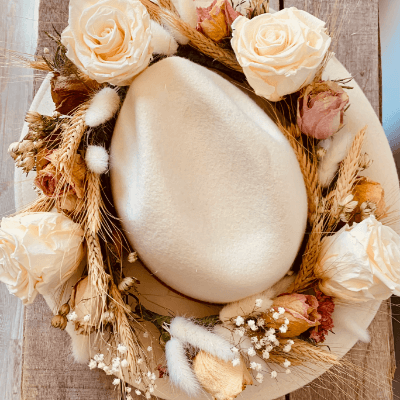 White decorative egg surrounded by white flowers.
